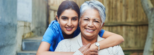 caretaker hugging senior woman