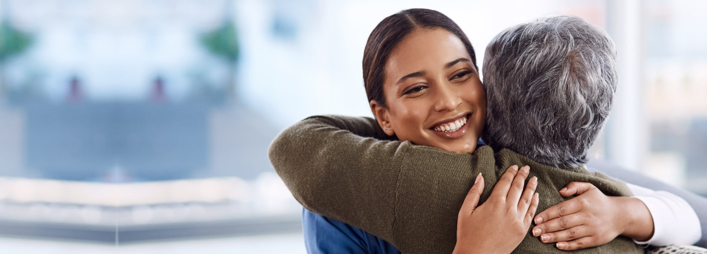 senior woman hugging with her caretaker